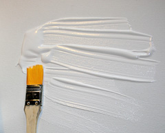 Gesso is applied in layers to the canvas to prepare it for painting