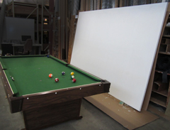 A stretched artist's blank canvas, with pool table for reference