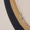 Close up view of hanging hardware on a round canvas