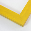 Simple 1-9/16 " molding. This frame has a golden yellow stain over a natural wood finish. The yellow is laid with a brush stoke effect, giving it an uneven coating and leaving the base grain visible. It has a smooth, laminate texture.