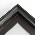 This bold 1-9/16 floater frame has a deep set bevel around the inside edge of the frame which adds depth to its contents. Overall this frame is dark chocolate brown in color, accented by lighter streaks in a grain pattern. The inside of the bevel is stained a subtle green-grey with wood grain showing through.