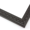 This slim, ornamented design features bevelled inner and outer edges and a celtic cross  pattern in relief.  The solid wood frame is covered in a matte black, while a subtle red patina gives it an antiqued look.

1.25 " width: ideal for smaller artwork.  Photographs, paintings and giclee prints will shine within this detailed frame.