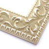 A large, reverse curve profile frame with an intricate leaf design bordered by a geometric outer edge and beaded inner lip.  The cream-colour base features a white patina for added depth on the topmost points of the design. Strong, solid wood construction.

2.75 " width: ideal for large and extra large images.