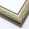 This highly detailed, solid wood frame features three distinct designs.  The dominant design tops a deep scoop of smooth, brushed silver foil and meets a small detail on the inner lip.  A drop ledge on the outer edge is decorated in a simple dash.  Matte areas within the designs create an antiqued look.

2 " width: ideal for medium- to large-size images. The detailed nature of this frame makes it suitable for bright or busy paintings or photographs.  It may overpower simpler images.