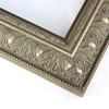Ornate 2 1/2 " frame with a beaded exterior ridge and a delicate leaf pattern across the face. The design is filled with a matte grey patina and the accents are a mix of warm silver and gold. The emphasis of gold versus silver can alter depending on the light and angle of viewing. The external edge is a solid mix of gold and silver.